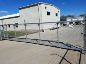 aluminum cantilever gate topped with barbed wire for commercial lot