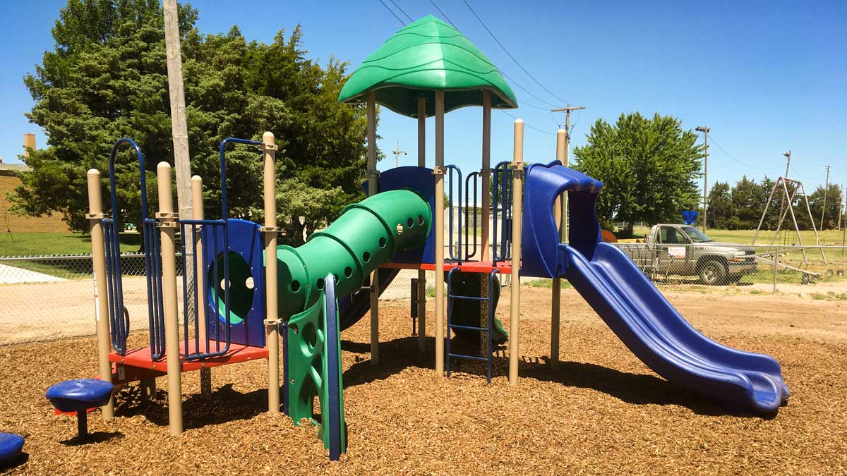 Play structure with slides, tunnel, and climbing elements. Playground company Fargo, North Dakota playground installation playground equipment slides swings surfacing climbers children recreation safety durable